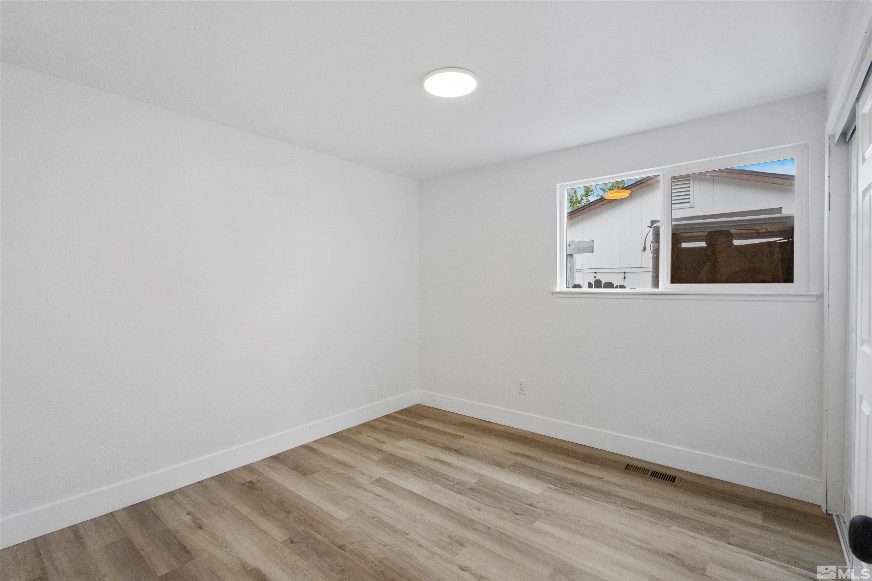 6798 Flower Street Reno, NV 89506 - Photo 12 of 22 a view of empty room with wooden floor