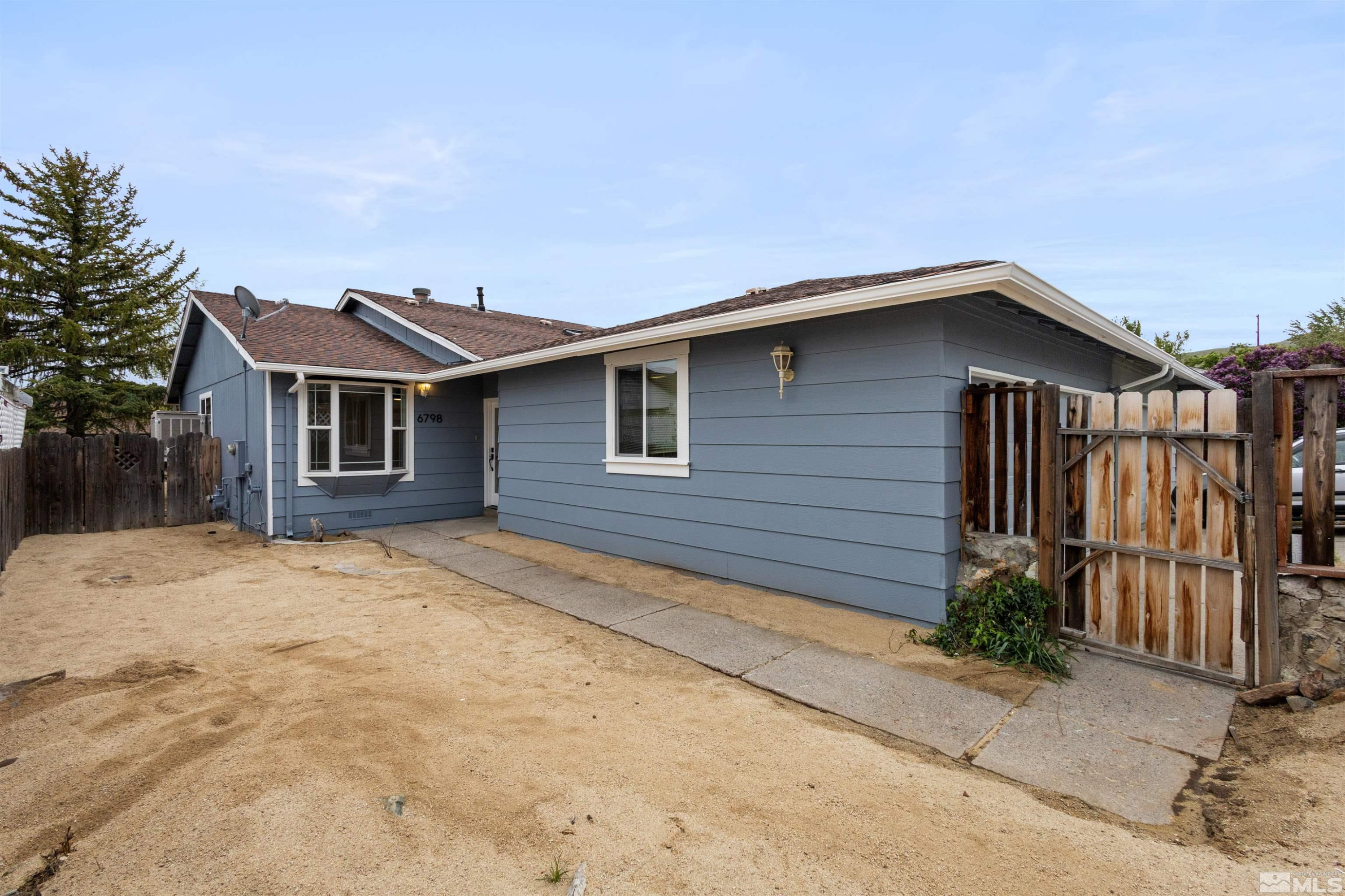 6798 Flower Street Reno, NV 89506 - Photo 14 of 22 a front view of a house with garage
