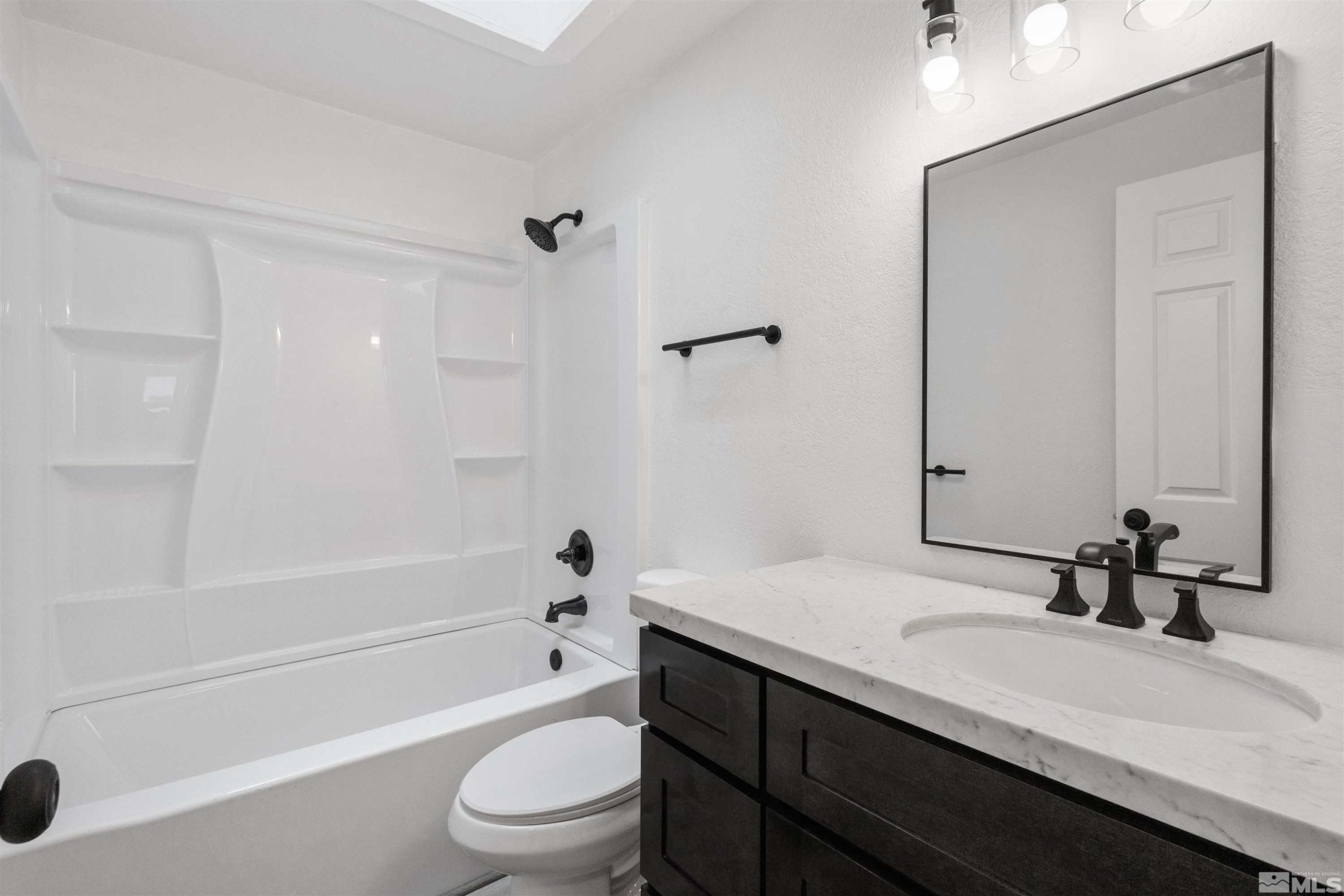 6798 Flower Street Reno, NV 89506 - Photo 15 of 22 a bathroom with a sink a toilet and a bathtub