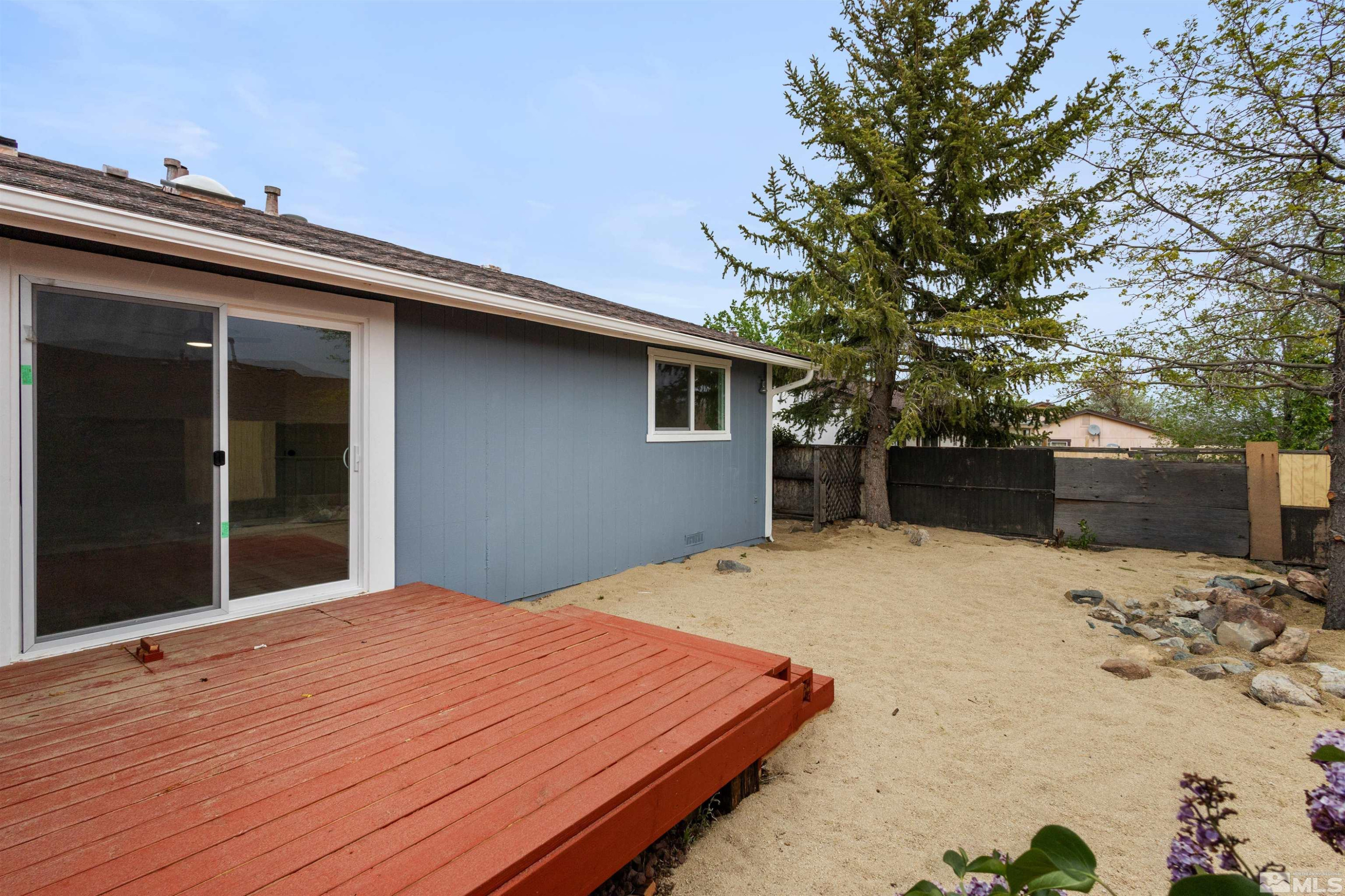 6798 Flower Street Reno, NV 89506 - Photo 18 of 22 a backyard of a house with a large tree