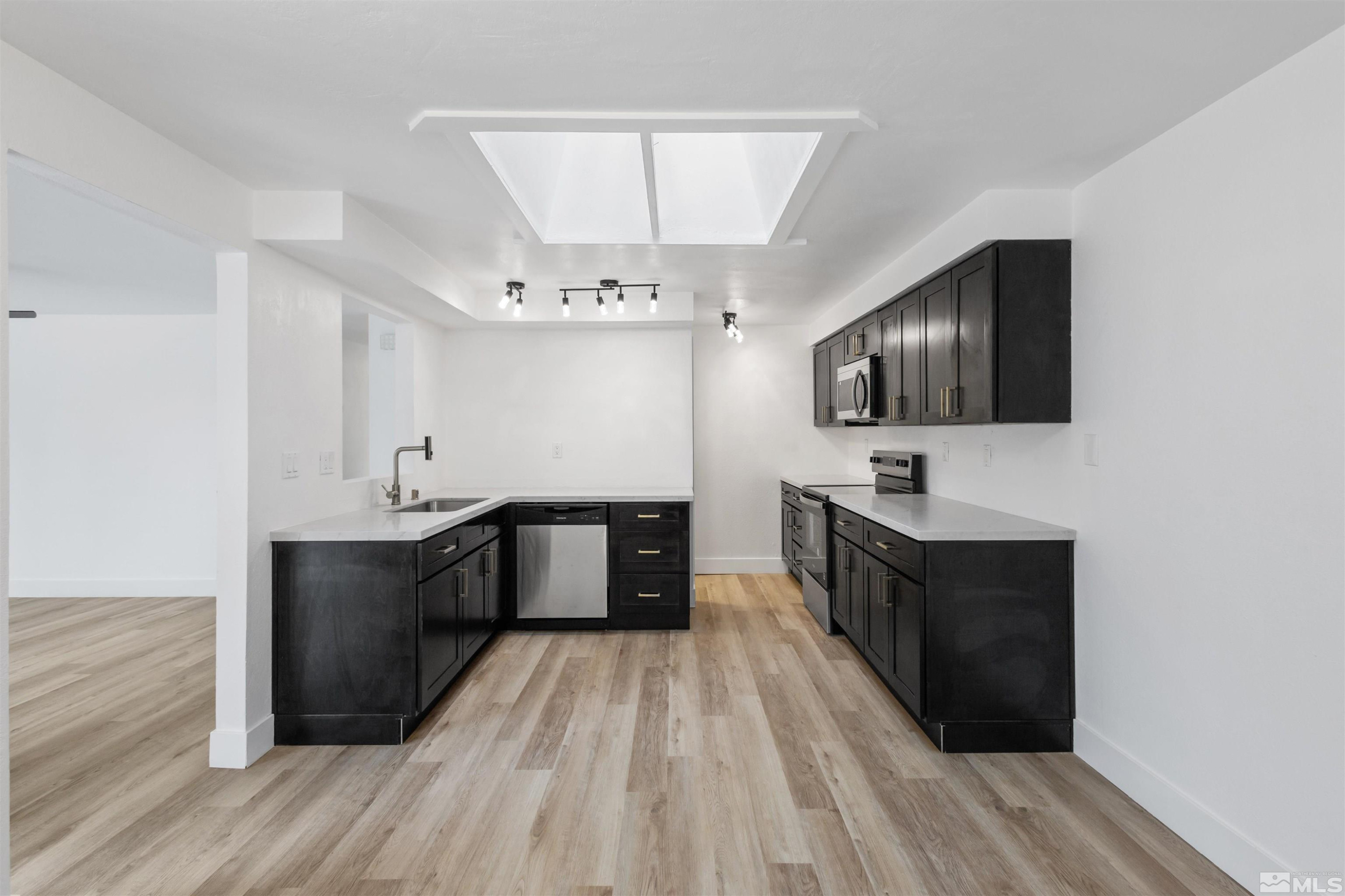 6798 Flower Street Reno, NV 89506 - Photo 2 of 22 a spacious bathroom with a double vanity sink and a mirror