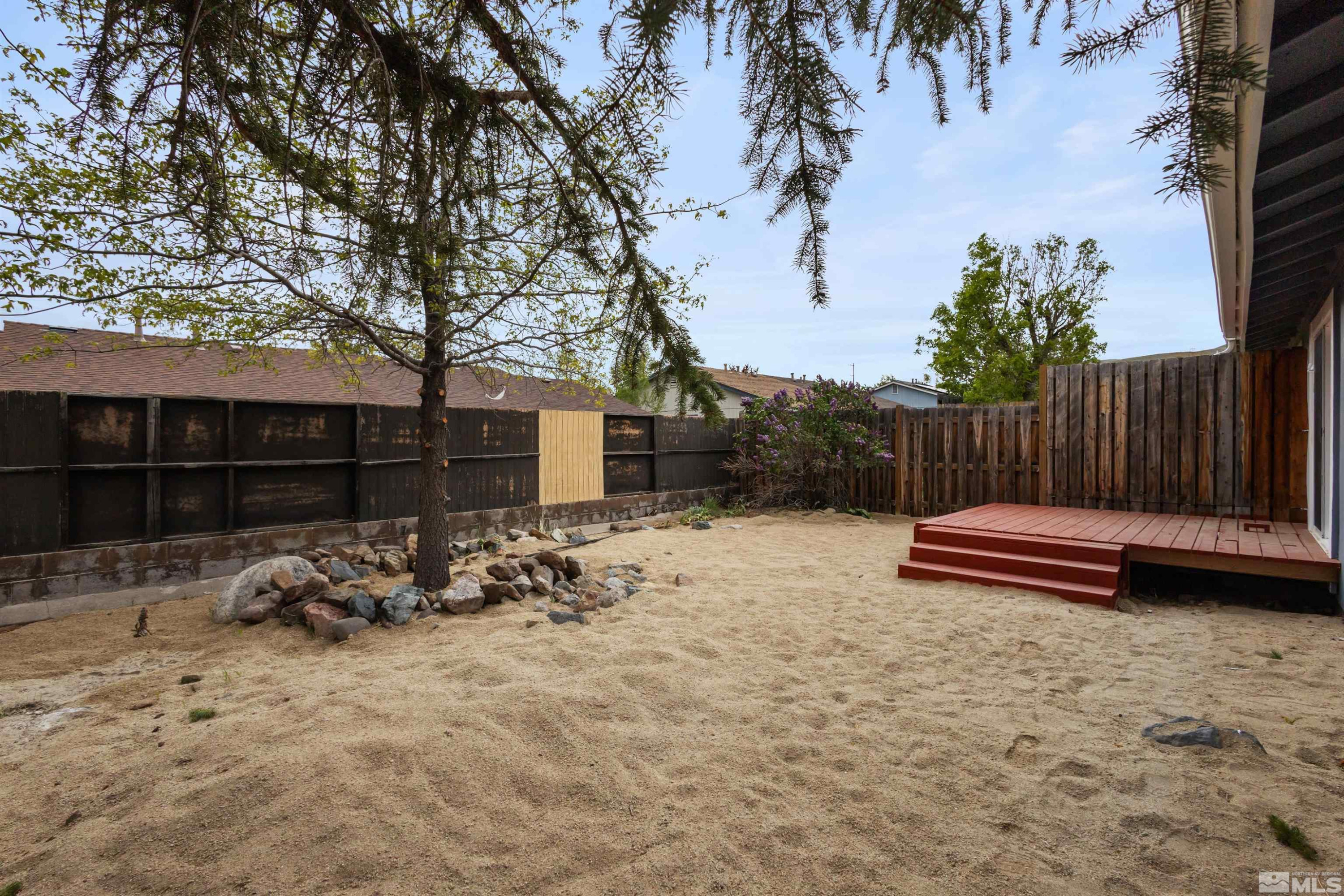 6798 Flower Street Reno, NV 89506 - Photo 21 of 22 a backyard of a house with barbeque oven and outdoor seating