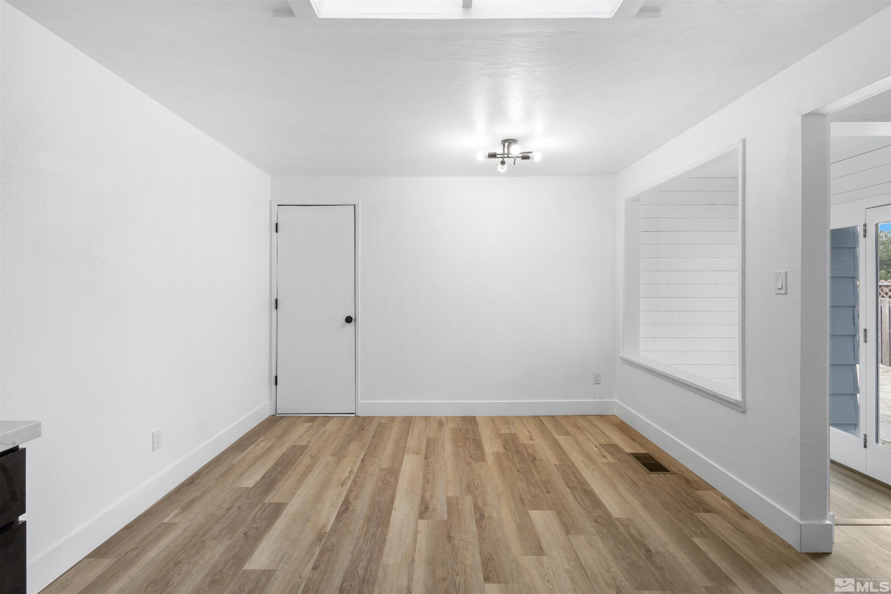 6798 Flower Street Reno, NV 89506 - Photo 8 of 22 a view of room with a window and hardwood floor