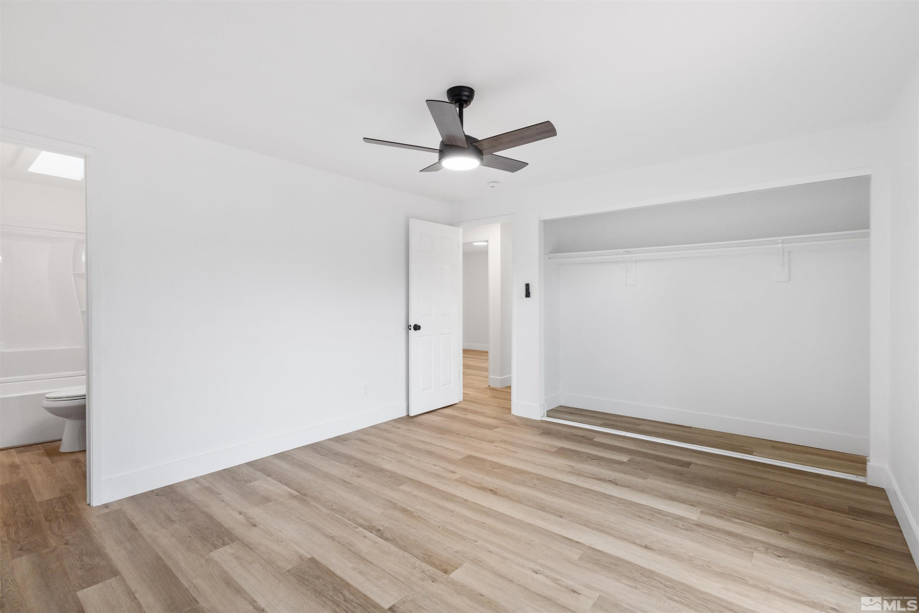 6798 Flower Street Reno, NV 89506 - Photo 10 of 22 a view of a room with wooden floor and a ceiling fan