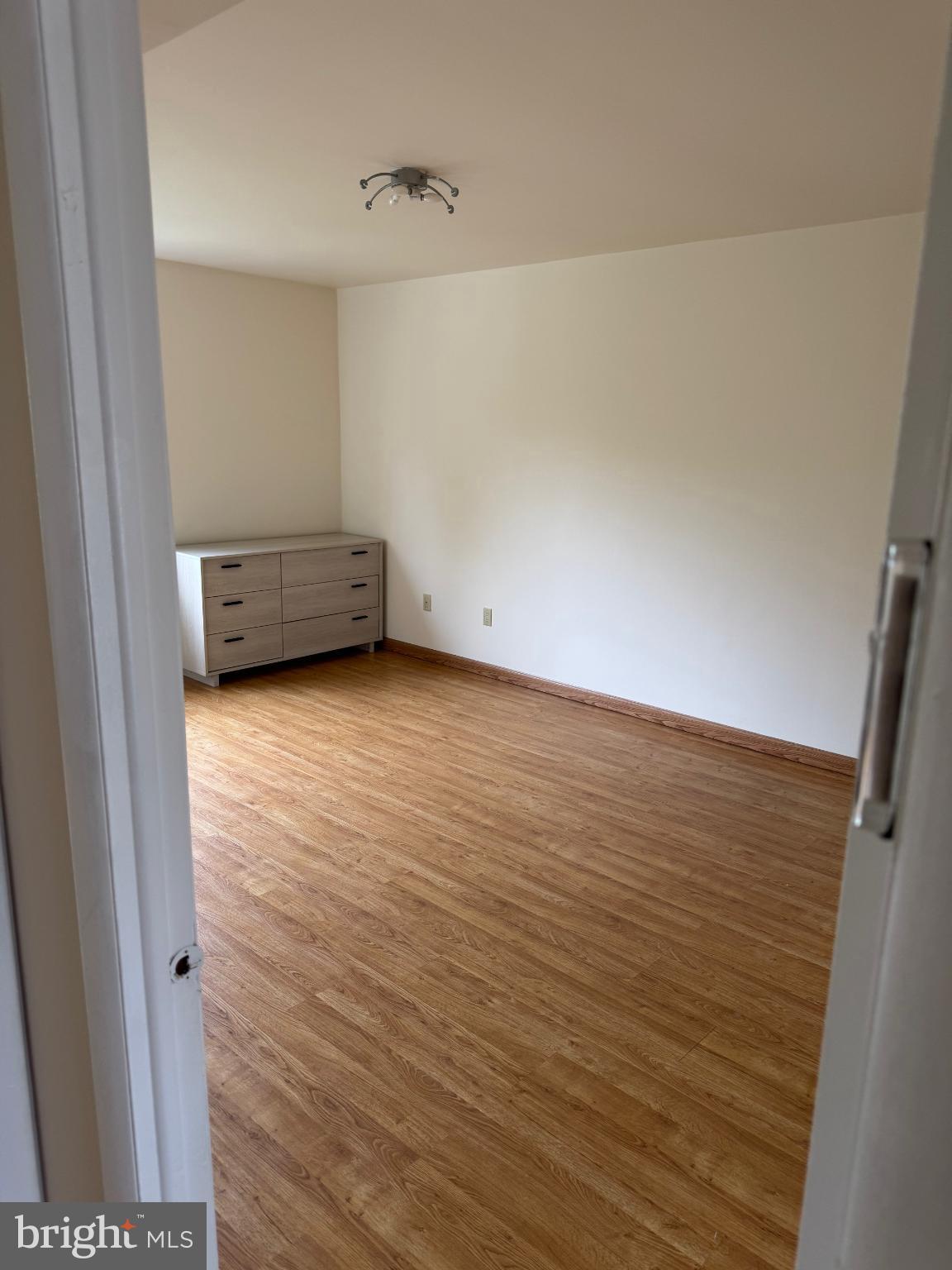 9908-00 Bustleton Avenue, Unit D2 Philadelphia, PA 19115 - Photo 9 of 11 a view of an empty room with wooden floor