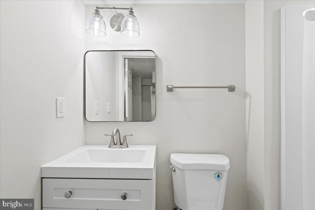 2004 Wolf Street Fort Washington, MD 20744 - Photo 28 of 39 a bathroom with a sink a toilet and mirror