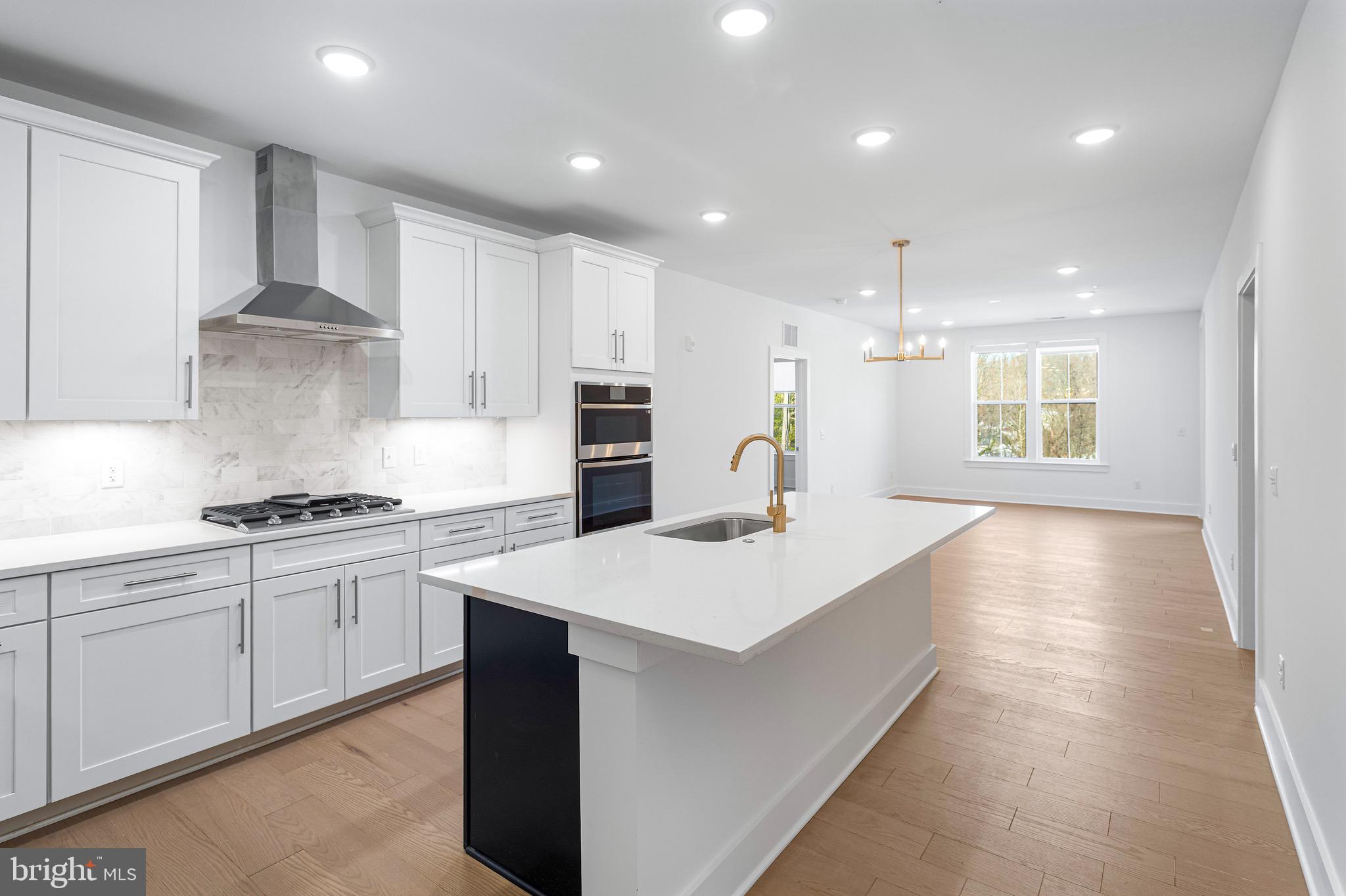 76 Old Mill Bottom Road North, Unit 205 Annapolis, MD 21409 - Photo 15 of 34 a large kitchen with stainless steel appliances lots of counter space and wooden floor