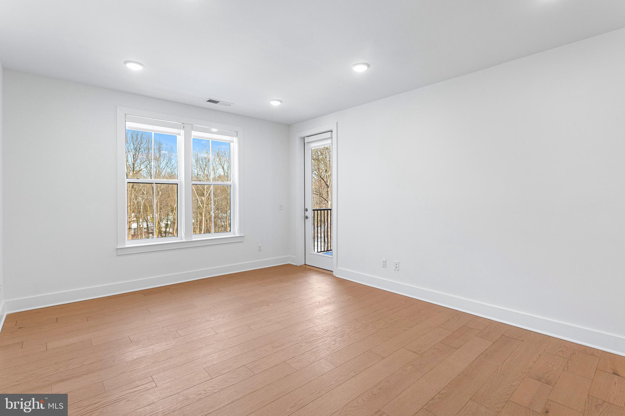 76 Old Mill Bottom Road North, Unit 205 Annapolis, MD 21409 - Photo 19 of 34 an empty room with wooden floor and windows