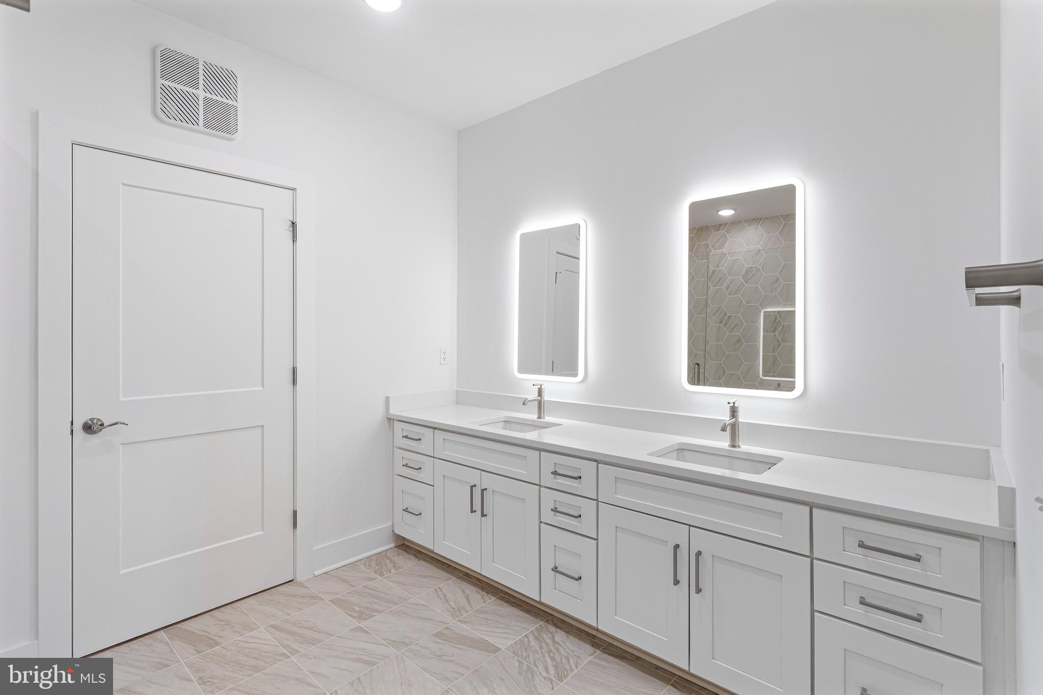 76 Old Mill Bottom Road North, Unit 205 Annapolis, MD 21409 - Photo 22 of 34 a bathroom with double sink and a mirror