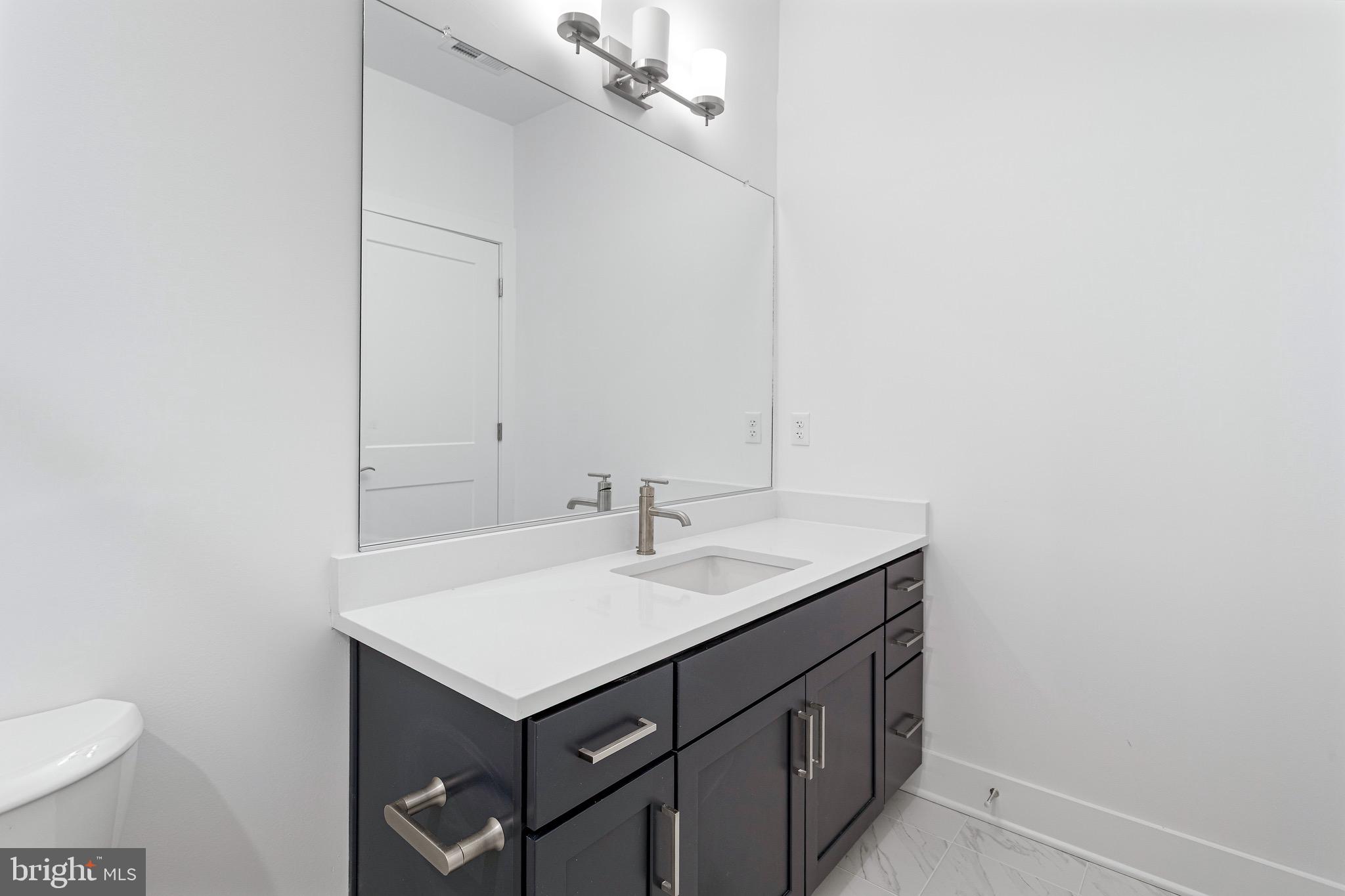 76 Old Mill Bottom Road North, Unit 205 Annapolis, MD 21409 - Photo 26 of 34 a bathroom with a sink and a toilet