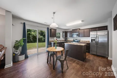 a kitchen with stainless steel appliances granite countertop a sink a stove and a refrigerator
