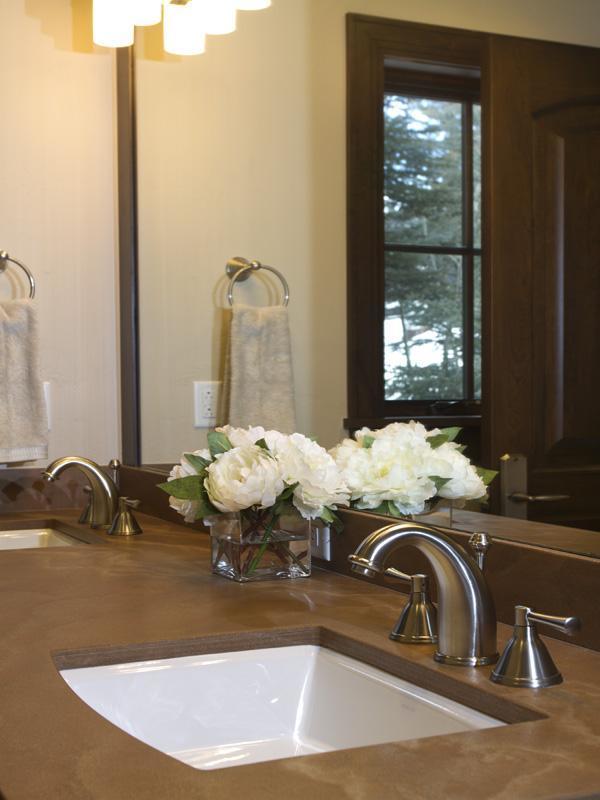 405 West Forest Road Vail, CO 81657 - Photo 21 of 22 a bathroom with a granite countertop sink and a mirror