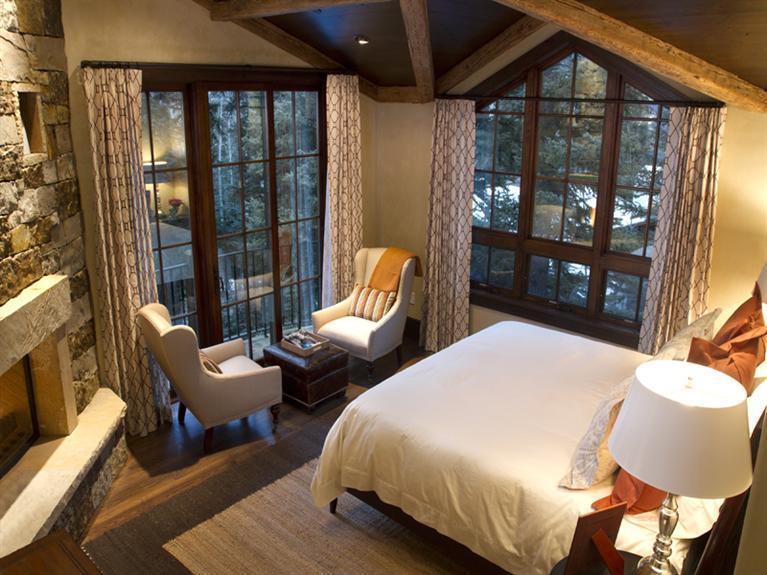 405 West Forest Road Vail, CO 81657 - Photo 9 of 22 a spacious bedroom with a bed and large windows