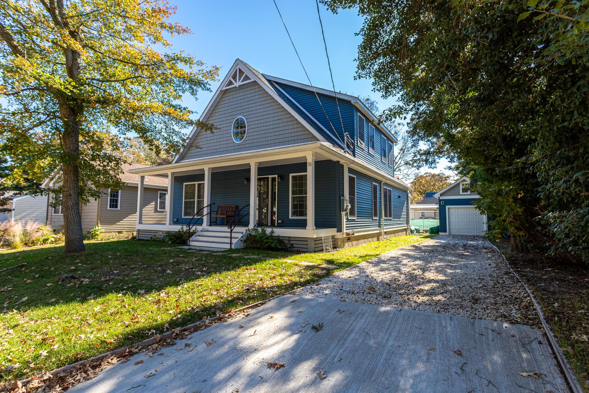 18 Cedarbrook Road Cape May, NJ 08204 - Photo 2 of 44 a front view of a house with a yard table and chairs