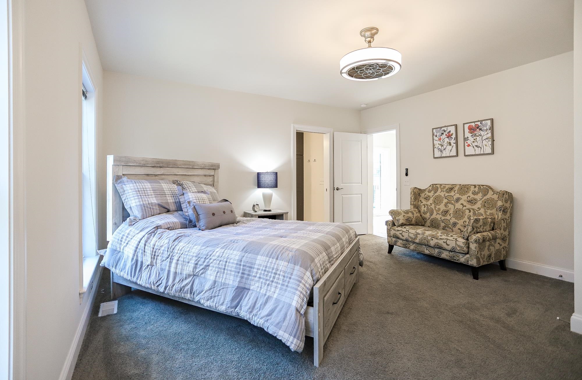 18 Cedarbrook Road Cape May, NJ 08204 - Photo 10 of 44 a bedroom with bed and a chandelier
