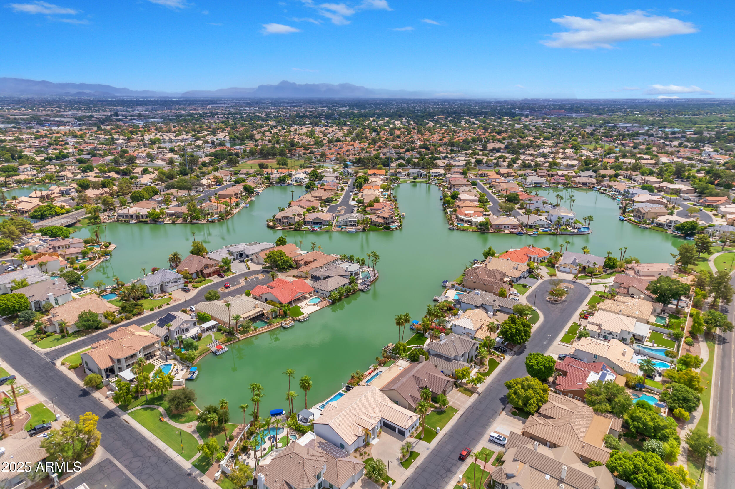 1333 North Cliffside Drive Gilbert, AZ 85234 - Photo 97 of 100 an aerial view of a city with lots of residential buildings ocean and mountain view in back