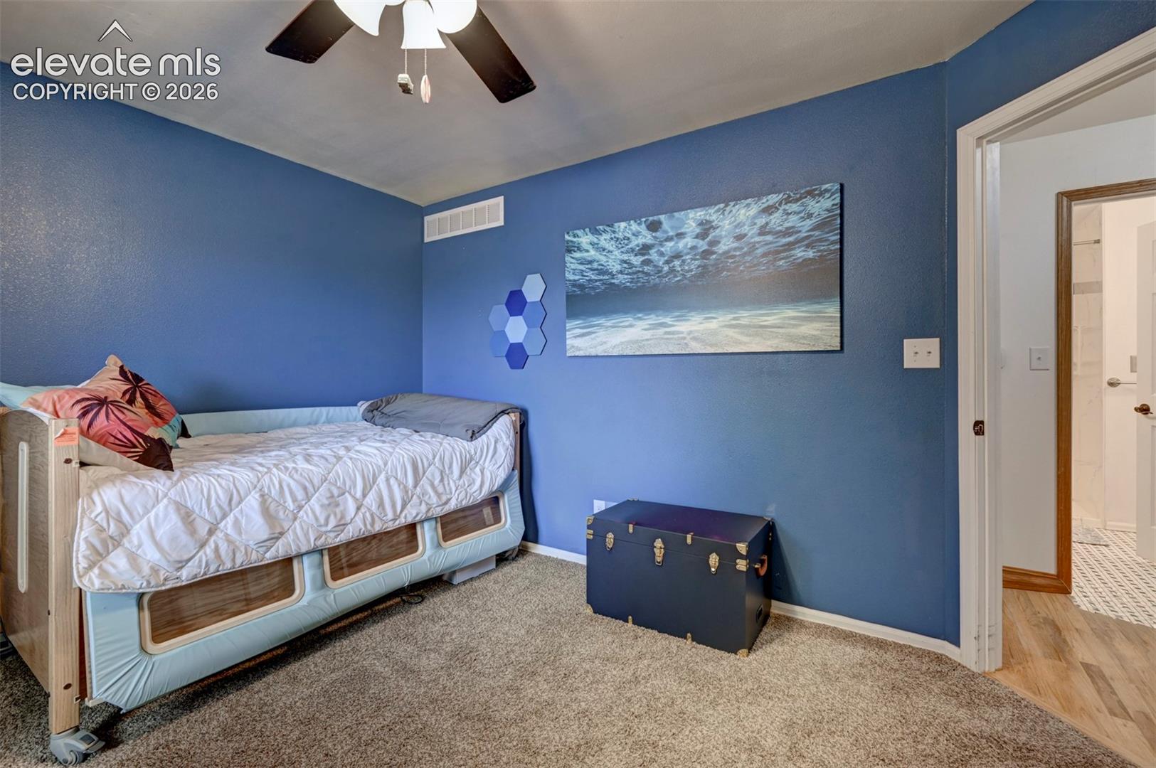 8170 Valli Farm Road Fountain, CO 80817 - Photo 24 of 50 Carpeted flooring, blue painted walls, and a ceiling-mounted fan with integrated lighting