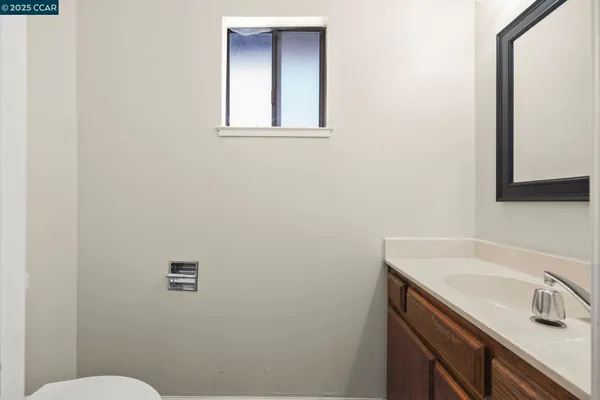 a bathroom with a sink a toilet and mirror