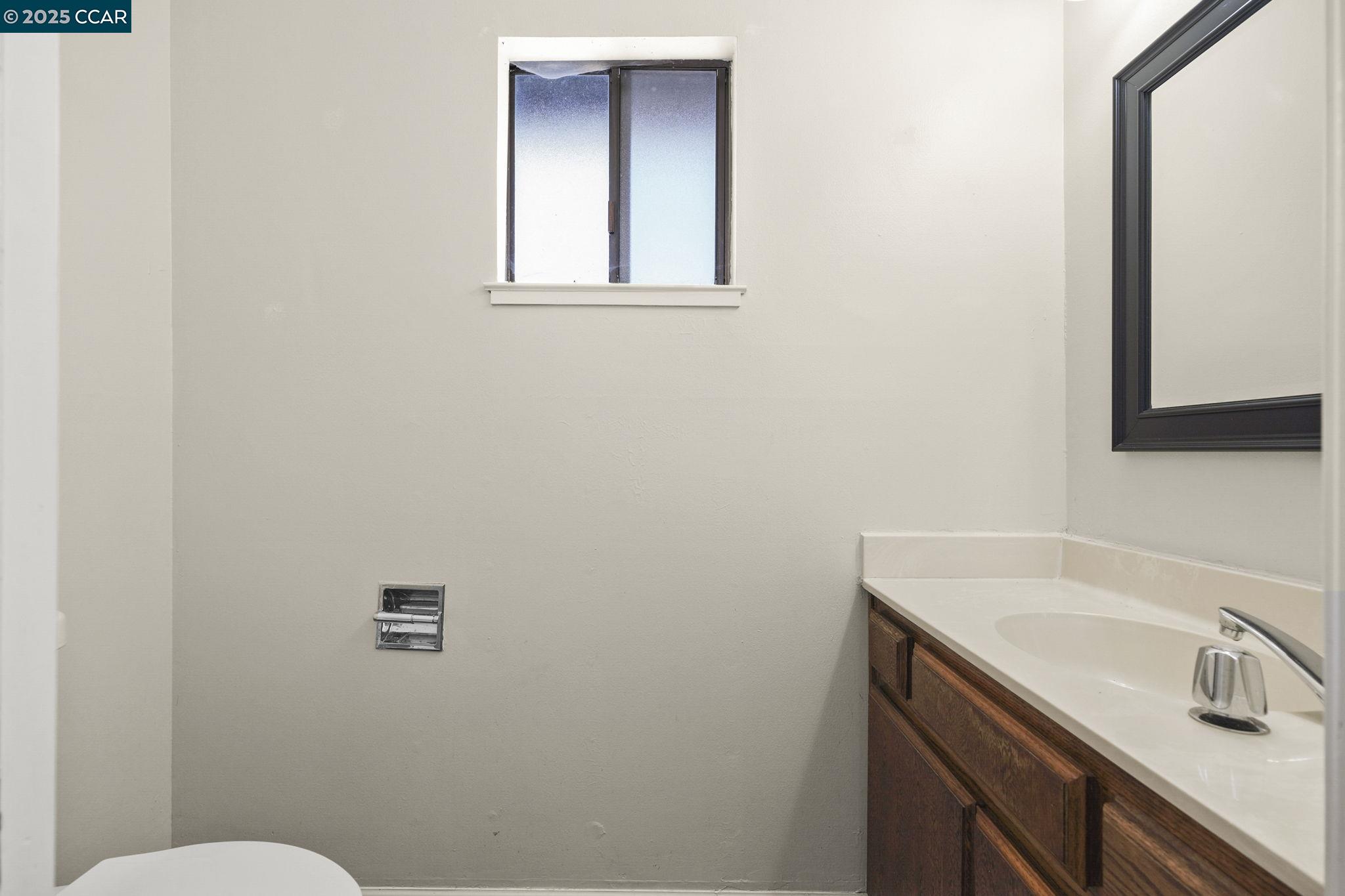 1610 Lawrence Road Danville, CA 94506 - Photo 12 of 36 a bathroom with a sink a toilet and mirror