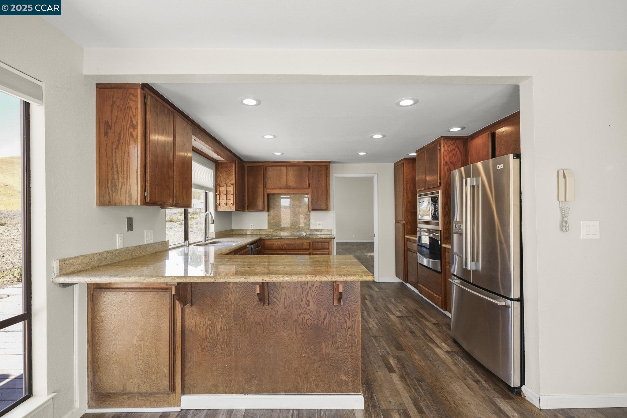 1610 Lawrence Road Danville, CA 94506 - Photo 24 of 36 a kitchen with stainless steel appliances granite countertop a refrigerator a sink and a stove