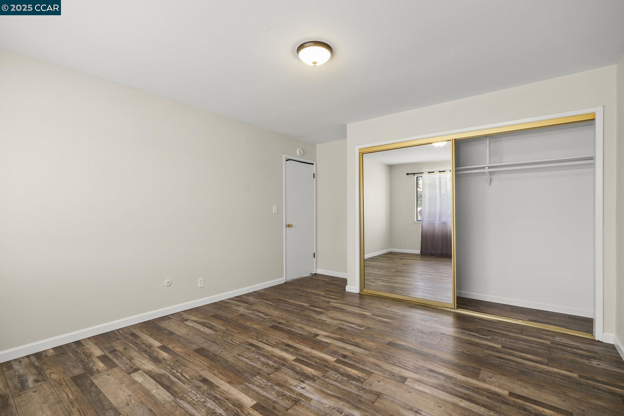 1610 Lawrence Road Danville, CA 94506 - Photo 29 of 36 a view of an empty room with wooden floor and cabinets