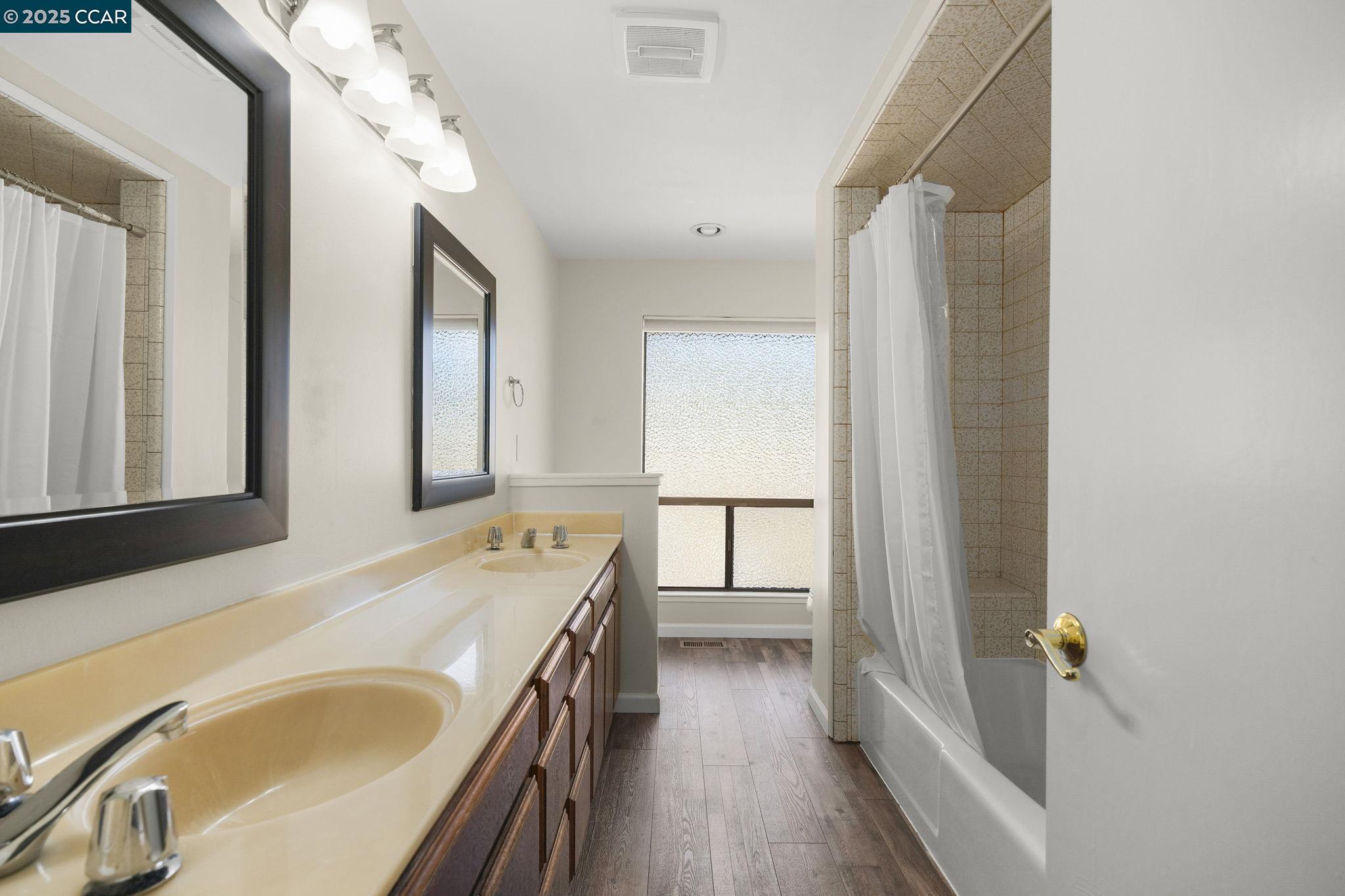 1610 Lawrence Road Danville, CA 94506 - Photo 31 of 36 a bathroom with a tub a sink and a large mirror