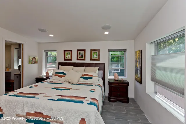 a bedroom with a large bed and a window