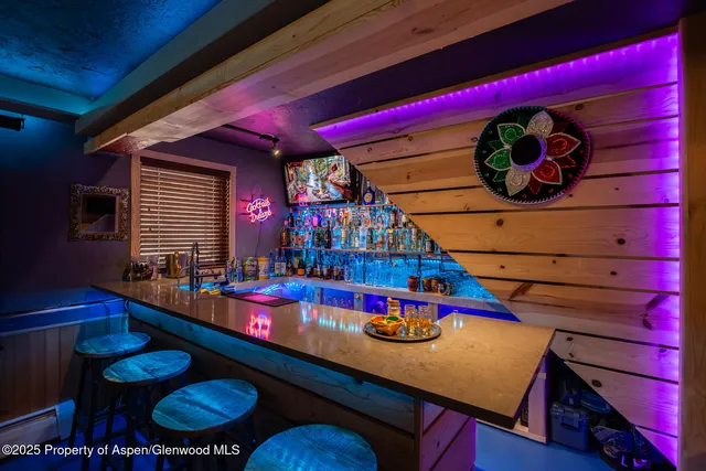 a living room with furniture flat screen tv and a large window