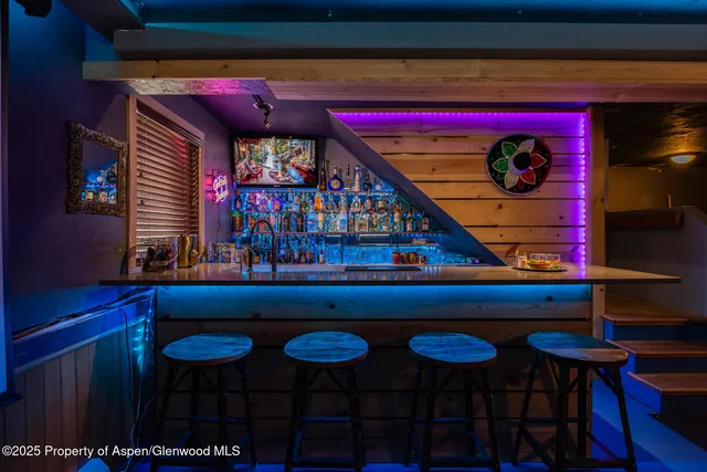 a room with furniture projector and screen