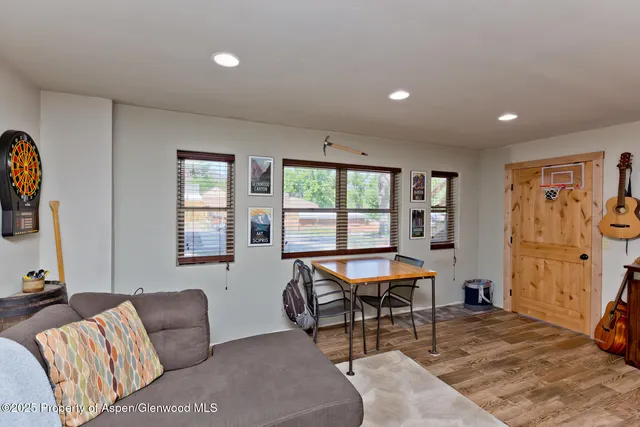 a view of a patio with table and chairs with wooden floor and fence
