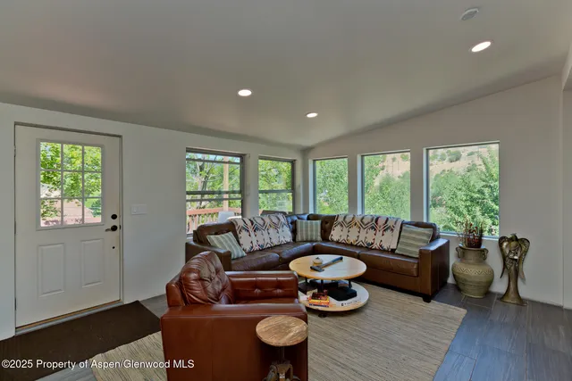 a living room with furniture and a large window