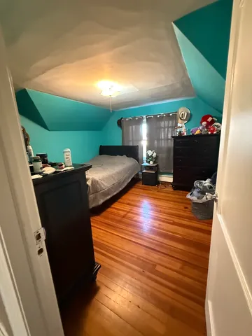 a room with wooden floor and furniture