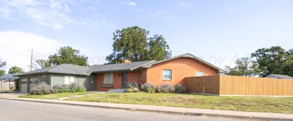 a view of a house with a yard and garage