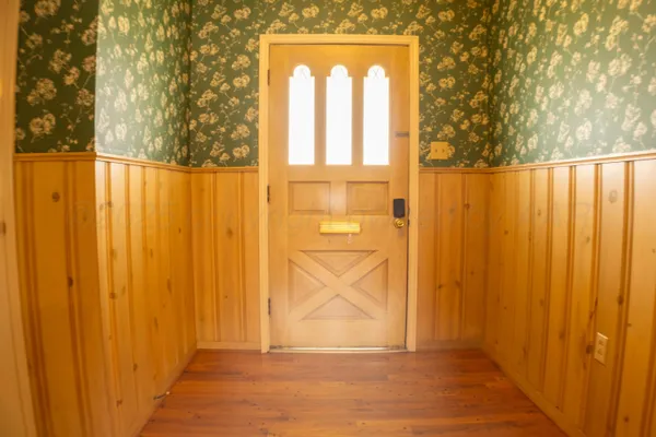 wooden floor fireplace and windows in an empty room