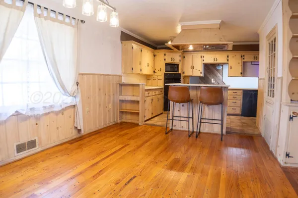 a view of kitchen with furniture and wooden floor