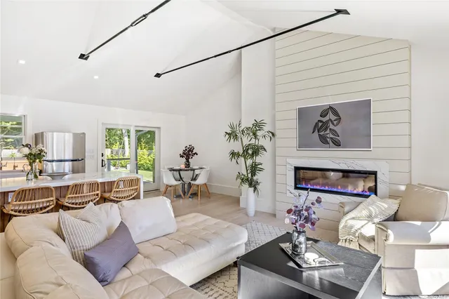 a kitchen with a dining table chairs and window