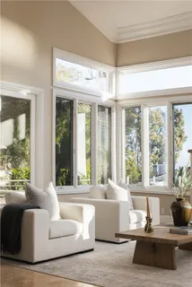 a living room with fireplace furniture and a chandelier