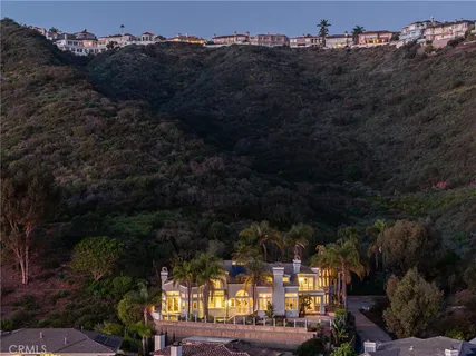 a living room with furniture a fireplace and large windows
