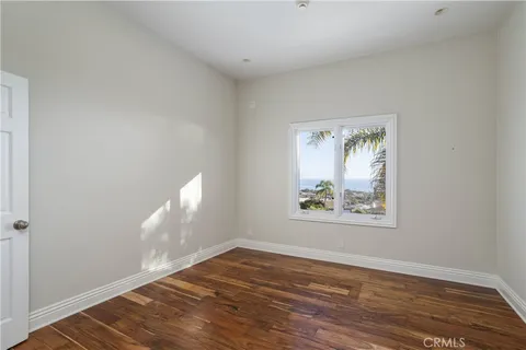 a front view of a house with a tree