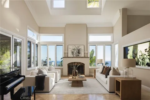 a kitchen with stainless steel appliances granite countertop a stove top oven a refrigerator a sink and chairs