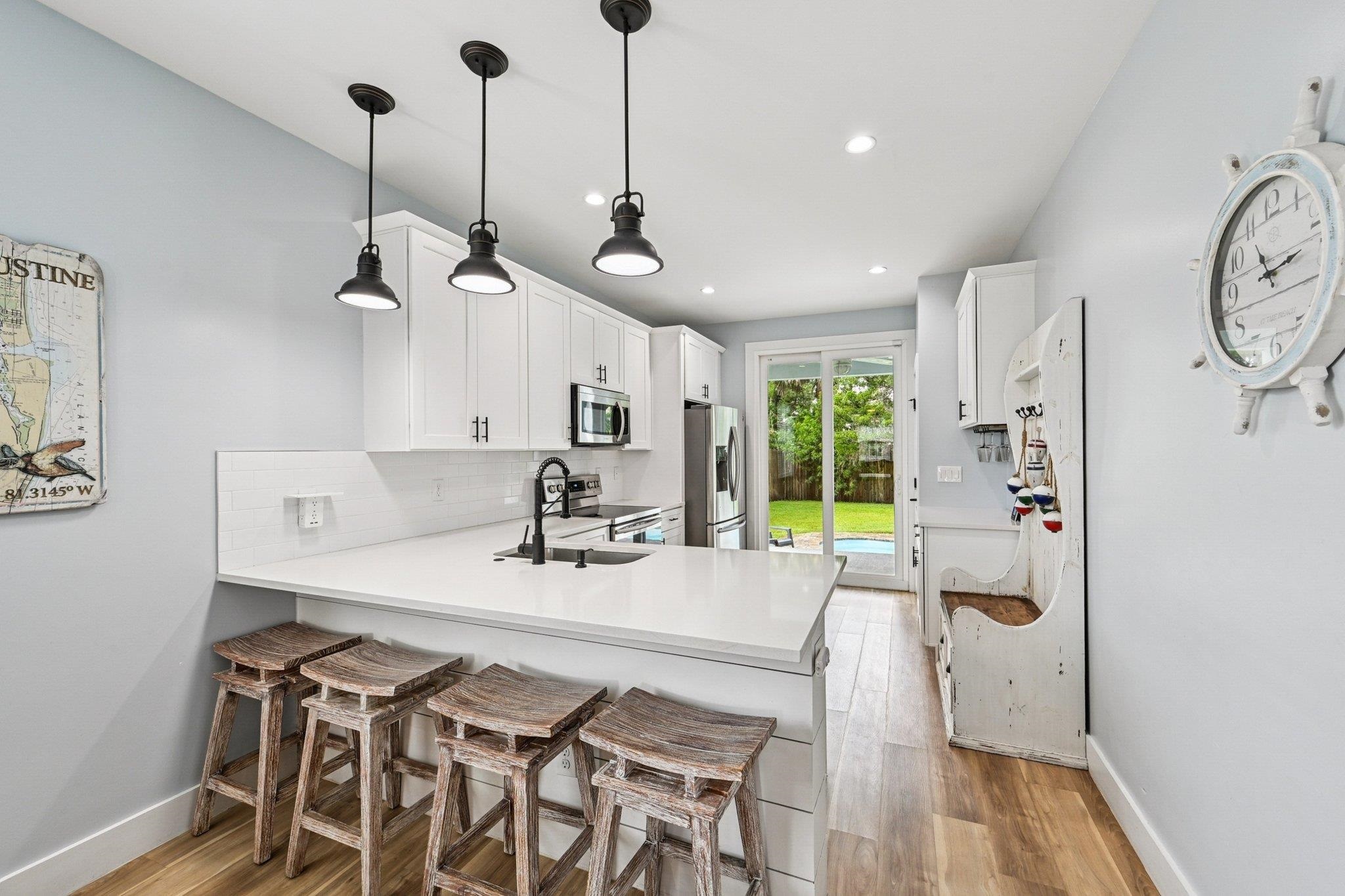 43 Menendez Road St. Augustine, FL 32080 - Photo 13 of 48 Kitchen with a kitchen bar, a peninsula, light wood-style flooring, white cabinetry, and recessed lighting