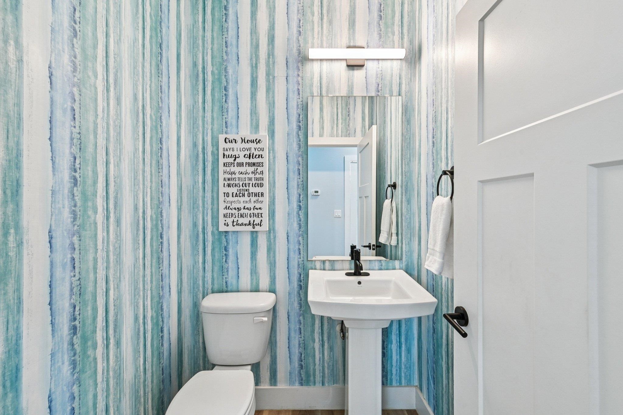 43 Menendez Road St. Augustine, FL 32080 - Photo 16 of 48 Bathroom with wallpapered walls and toilet