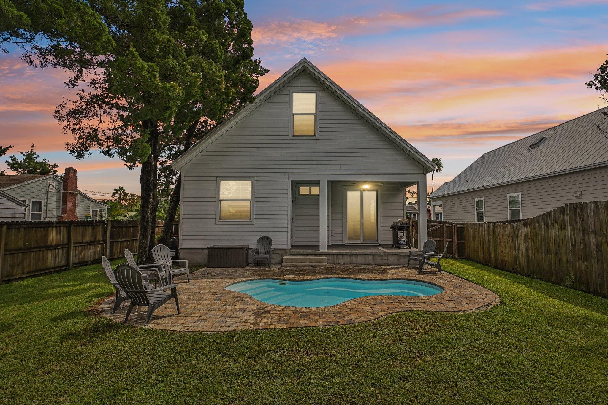43 Menendez Road St. Augustine, FL 32080 - Photo 34 of 48 Back of property at dusk with a patio and a fenced backyard