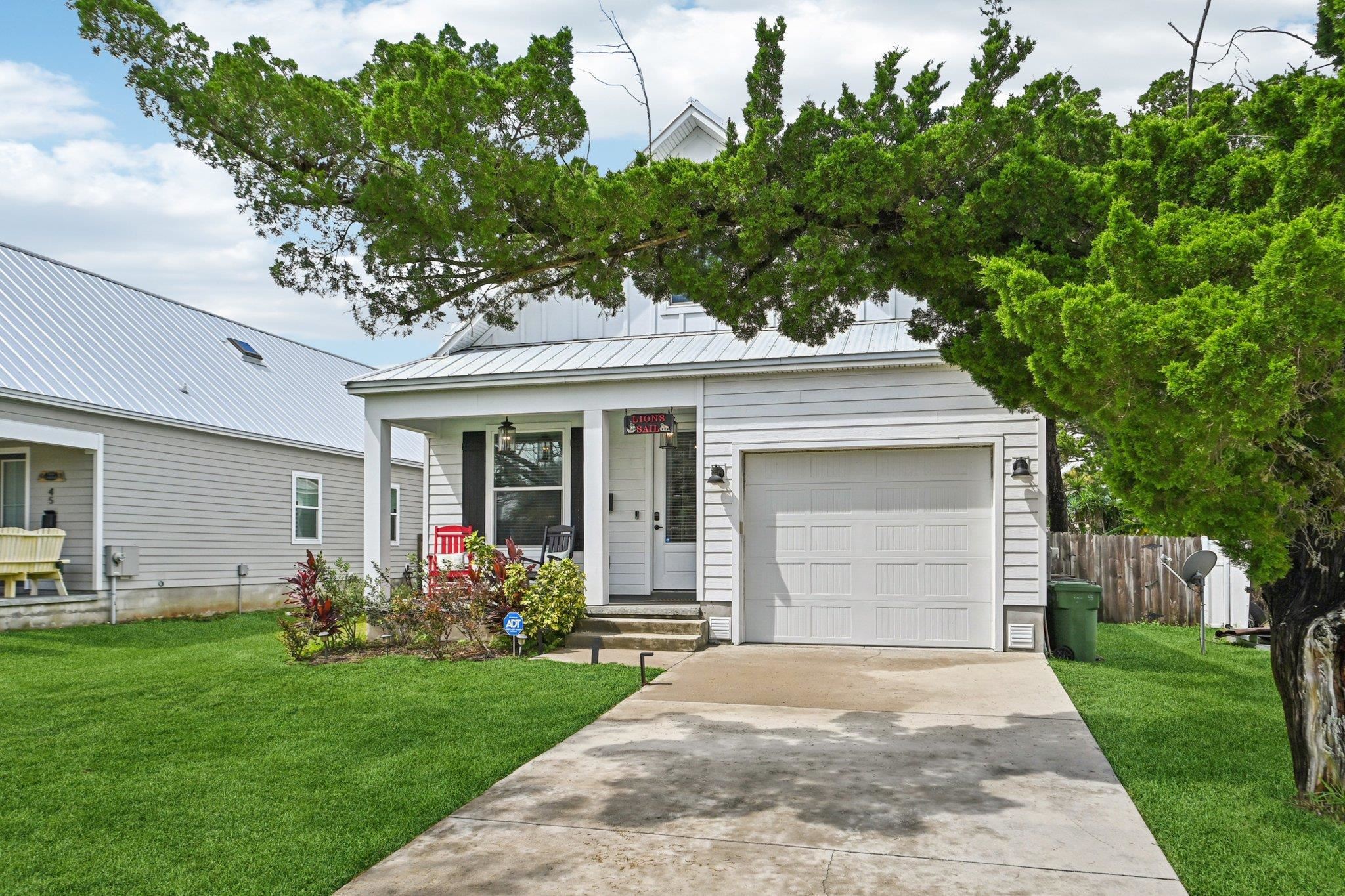 43 Menendez Road St. Augustine, FL 32080 - Photo 6 of 48 View of front facade featuring driveway, a porch, and a metal roof