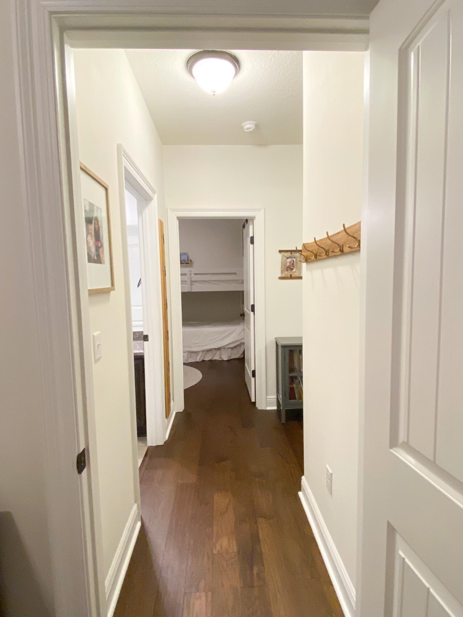 285 Maddox Street Santa Rosa Beach, FL 32459 - Photo 12 of 35 a view of a hallway with white walls and stairs