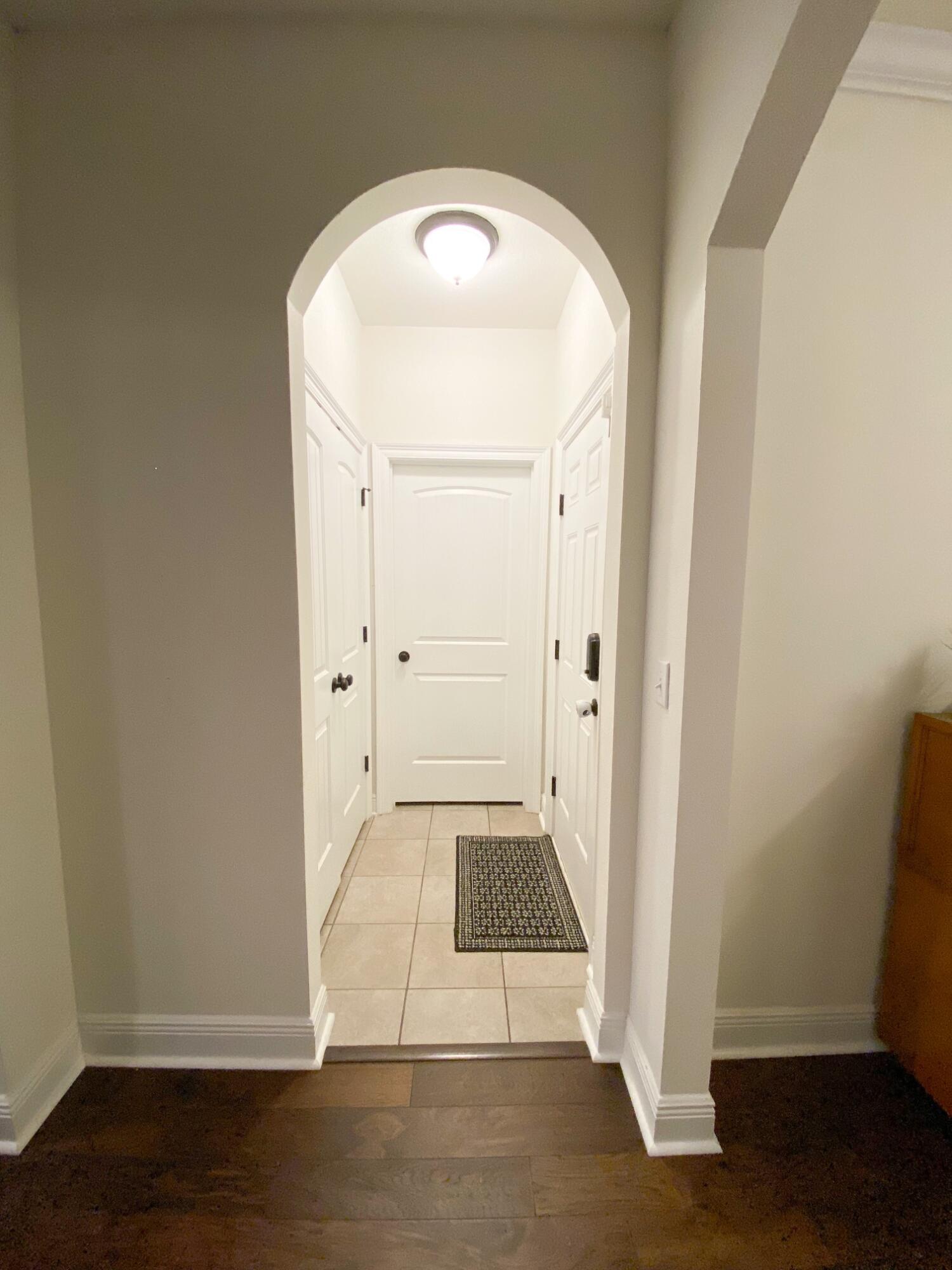 285 Maddox Street Santa Rosa Beach, FL 32459 - Photo 14 of 35 an empty room with wooden floor and entrance