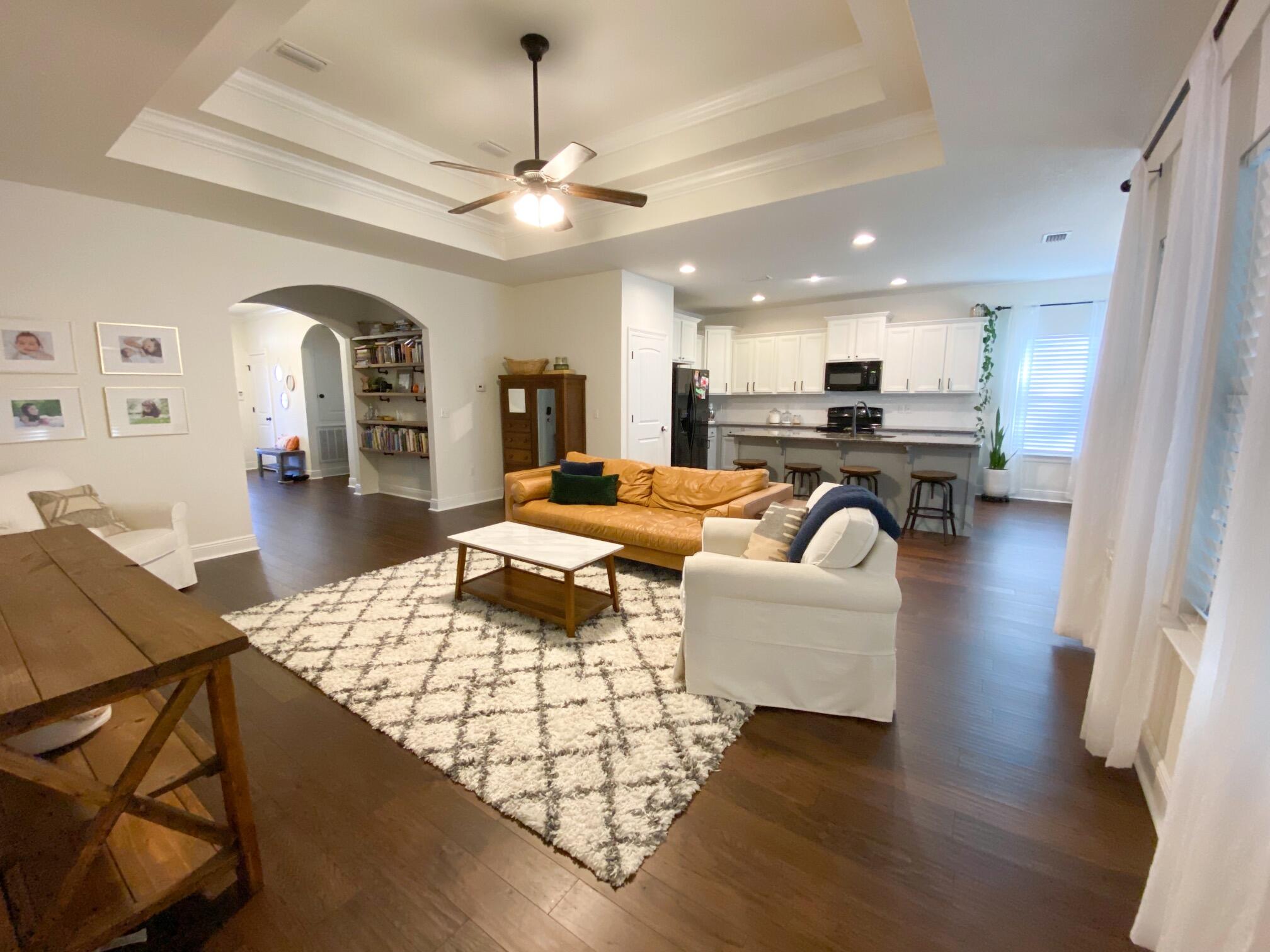 285 Maddox Street Santa Rosa Beach, FL 32459 - Photo 10 of 35 a living room with furniture kitchen view and a chandelier