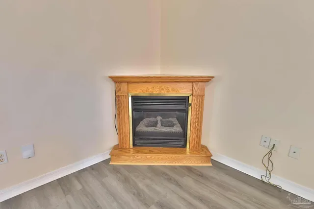 a view of an empty room and wooden floor