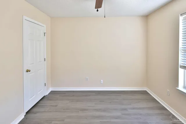 an empty room with wooden floor and a window
