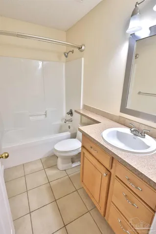 a bathroom with a sink mirror vanity and toilet
